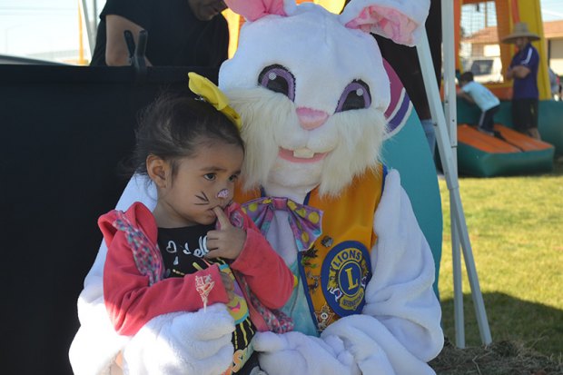 A local youth has fun with the Easter Bunny.